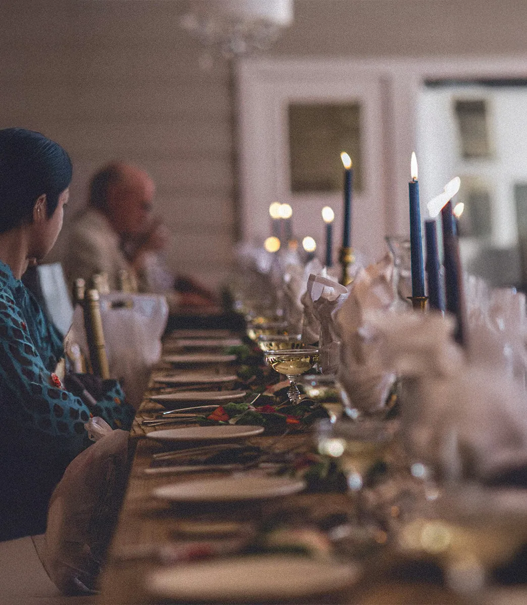Guests seated along a long table at a Vessel gathering